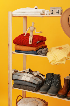 Wooden shelving with clothes, concept of autumn season clothes