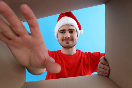 Concept of delivery, surprise, gift, young man opened a cardboard boxの写真素材