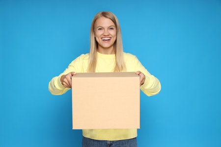 Concept of delivery, surprise, gift, young woman and cardboard box