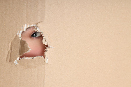Concept of delivery, surprise, gift, female eye and cardboard box textureの写真素材
