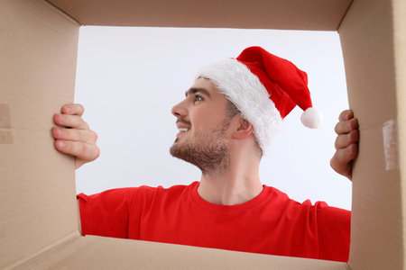 Concept of delivery, surprise, gift, young man opened a cardboard box