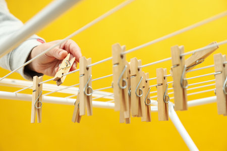 Clothespins hanging on drying rack, close upの写真素材
