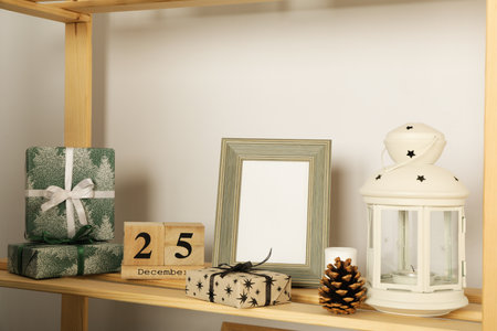 Shelving with New Year accessories and empty photo frameの写真素材