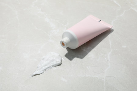 Blank pink tube of cream on light backgroundの写真素材