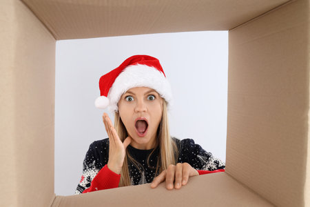 Concept of Christmas gift, young woman look in box