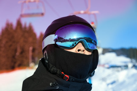 Skier in ski helmet and goggles in sunny dayの写真素材