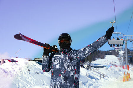 Skier in ski helmet and goggles in sunny dayの写真素材