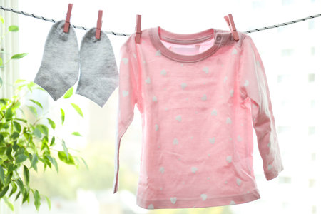 Pink child cloth and socks hanging on twine
