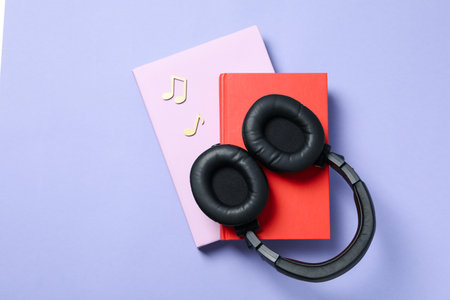 Concept of audiobook with books and headphones, top viewの写真素材