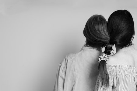 Concept of strong family bond, female twins, space for textの写真素材