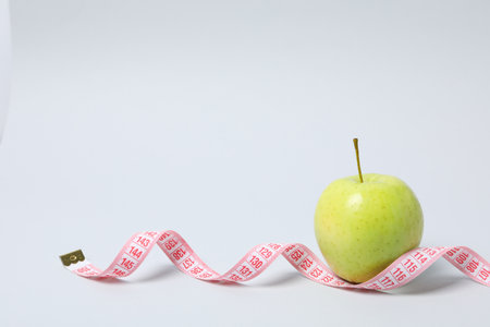 Diet and weight loss, healthy lifestyle, composition with measuring tape, space for text