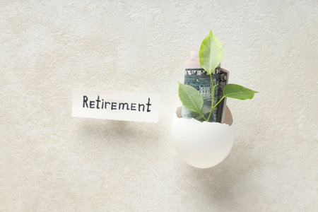 Composition with egg shell and money - retirementの写真素材