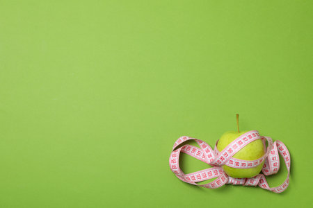 Diet and weight loss, healthy lifestyle, composition with measuring tape, space for textの写真素材