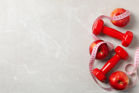 Diet and weight loss, healthy lifestyle, composition with measuring tape, space for textの写真素材