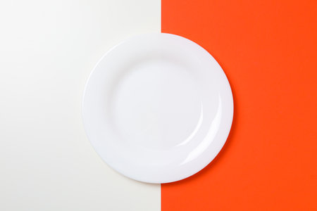 Empty plate on two tone background, top viewの写真素材