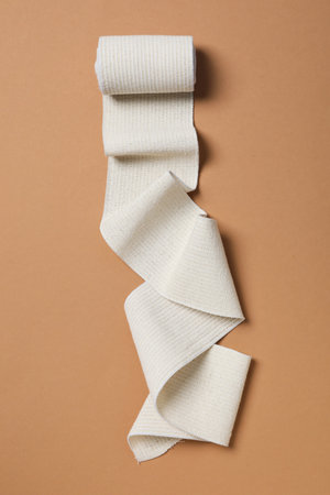 Help during an injury, elastic bandage on beige backgroundの写真素材
