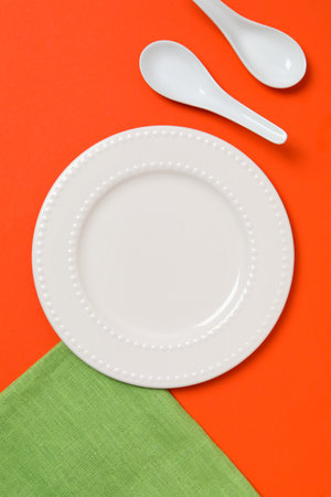 Minimal table setting with blank dish, top viewの写真素材