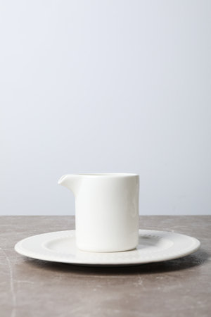 Minimal composition with dish on textured gray tableの写真素材