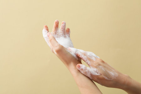 Hands with foam, spa, beauty procedures and skin care concept