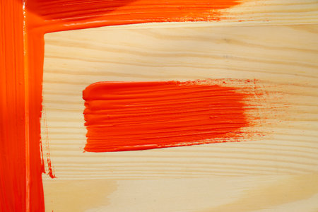 Red paint smear on wooden background, close upの写真素材