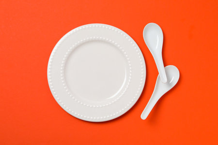Minimal table setting with blank dish, top viewの写真素材