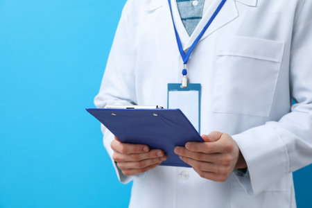 Doctor with clipboard on blue background - healthcare, Medical Workers Day conceptの写真素材