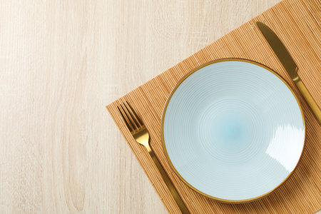 Minimal table setting with blank dish, space for textの写真素材