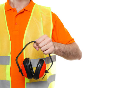 Civil engineer holds protective ear muffs, isolated on white backgroundの写真素材