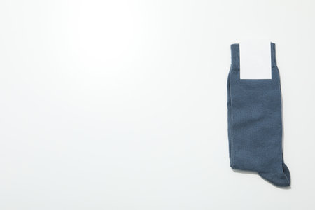Socks with blank label on white background, space for textの写真素材