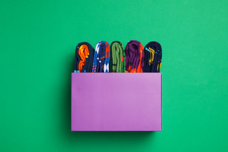Box with socks on green background, top viewの写真素材