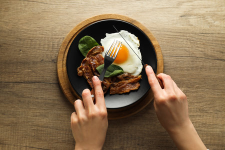 Fried bacon and egg - tasty breakfast, top viewの写真素材