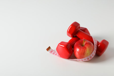 Concept of weight loss and healthy nutrition with apple and measuring tapeの写真素材