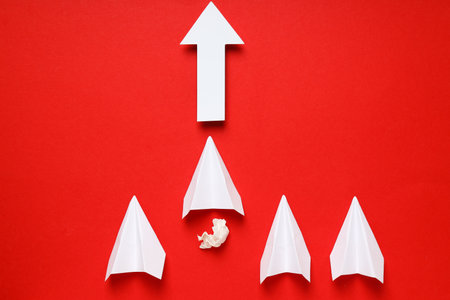 Business, startup and sponsorship concept with paper planes on red backgroundの写真素材