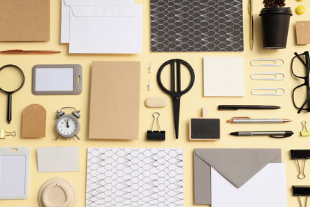 Mockup flat lay with different office accessories on beige backgroundの写真素材