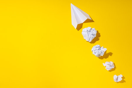 Business, startup and sponsorship concept with paper plane on yellow backgroundの写真素材