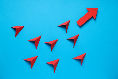 Business, startup and sponsorship concept with arrows on blue backgroundの写真素材