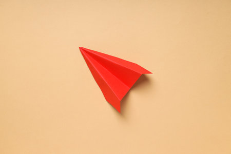 Business, startup and sponsorship concept with paper plane on beige backgroundの写真素材