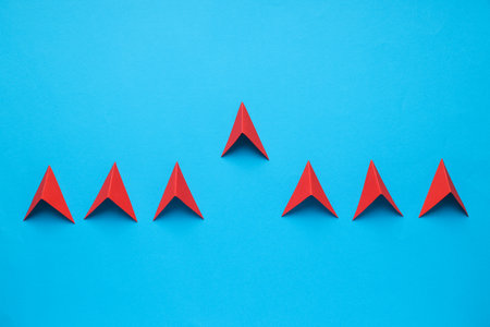 Business, startup and sponsorship concept with arrows on blue backgroundの写真素材