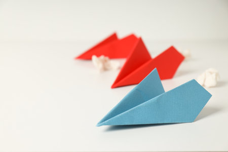 Business, startup and sponsorship concept with paper planes on white background
