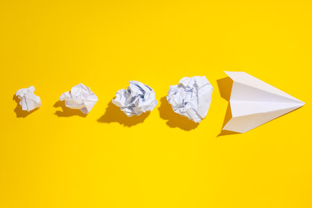 Business, startup and sponsorship concept with paper plane on yellow backgroundの写真素材