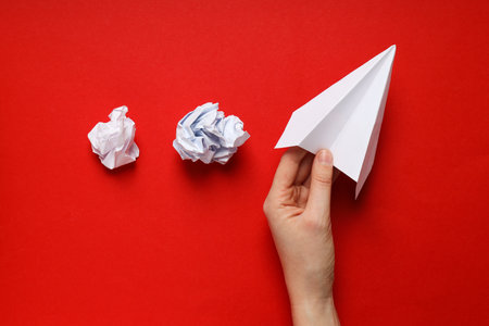 Business, startup and sponsorship concept with paper plane on red backgroundの写真素材