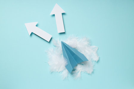 Business, startup and sponsorship concept with paper plane on blue background