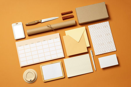 Mockup flat lay with freelancer office accessories on beige backgroundの写真素材