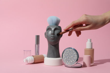 Makeup concept with decorative head on pink backgroundの写真素材