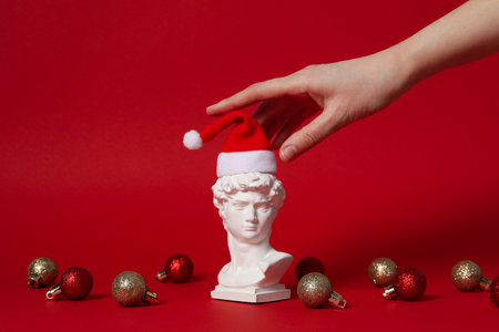 Christmas concept with ancient head on red background