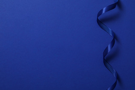 Concept of different ribbons, blue ribbon on blue backgroundの写真素材