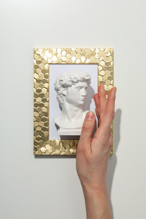 Photo frame with ancien head on white backgroundの写真素材