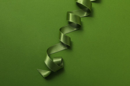 Concept of different ribbons, green ribbon on green backgroundの写真素材