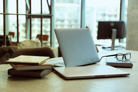 Office table with coffee, laptop and office papers, notebooksの写真素材
