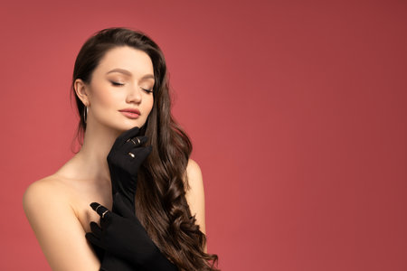 Girl with long wavy hair, wearing mittensの写真素材